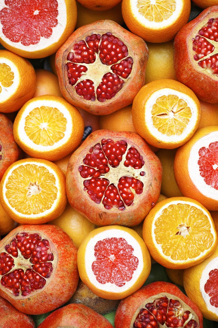 Colorful mix of sliced citrus fruits and pomegranates showcasing freshness.