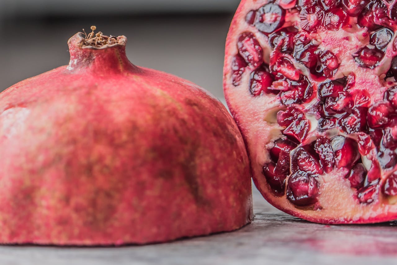 Vibrant close-up of a juicy pomegranate slice showcasing fresh seeds and rich color.